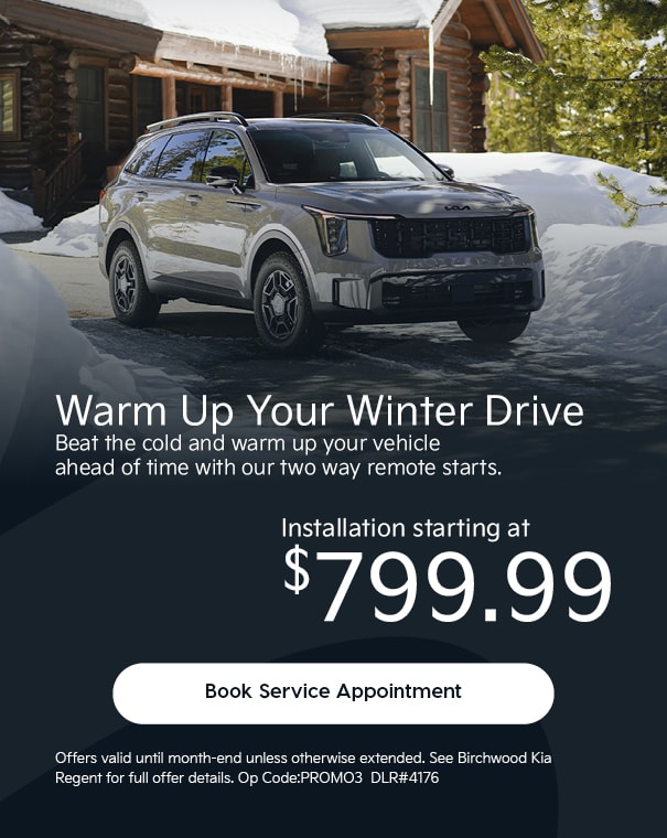 Grey Kia SUV parked in a snowy driveway in front of a cabin, promoting two-way remote start installation starting at $799.99, with a “Book Service Appointment” button and Birchwood Kia Regent offer details.